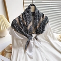Detail of silk-feel scarf with black Greek Key patterns on white satin shirt - White