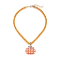 Detail of orange checkered pumpkin pendant with pink bow on braided cord necklace - Plaid Pumpkin Bag