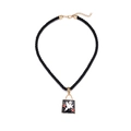 Detail of square black enamel ghost pendant with red stars on a twisted rope necklace - Pocket Ghost