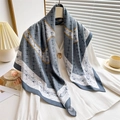 Silk-like square scarf with grey blue borders and interlocking patterns on a white shirt - Gray