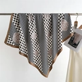 Detail of silk square scarf featuring black houndstooth pattern and camellia floral print - Khaki Edge