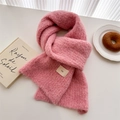 Detail of pink fleece knit scarf showing soft texture and minimalist woven label - Pink
