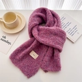 Detailed texture of purple melange knit scarf with ins woven label on white table - Pink Purple