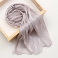 Close-up of light purple silk scarf with smooth texture displayed on a wooden tray - 180x70cm / Nude