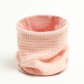 Detail of pink knitted neck warmer with waffle texture and thick fleece lining - Pink