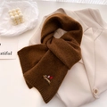 Close-up of dark brown knit scarf featuring detailed dog embroidery and soft texture - 164x20cm / Brown