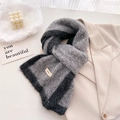 Detailed texture of thick knit grey and black wool scarf with woven brand label - 166x20cm / Medium Grey