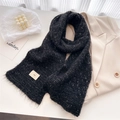 Close-up of black speckled wool knit scarf with tassel fringe and minimalist ins label - 160x21cm (Including Tassels) / Black
