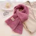 Detail of rose pink knit scarf with Bonogeed label and thick brushed wool texture - 161x21cm / Pink