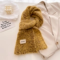 Soft mustard yellow wool knit scarf with brand label styled on a beige blazer background - 161x21cm / Yellow