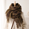 Detailed view of dark brown plaid cashmere scarf with long fringe on a wooden mannequin - Coffee Yellow