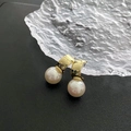 Elegant gold curved hoop earrings with white pearls on a textured black background - Imitation Pearl Earrings (1-8#22)