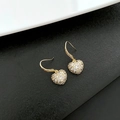Golden heart-shaped drop earrings with pavé set crystals on a black background - Gold Heart Pavé Zirconia Earrings (1-1-11)