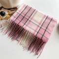 Soft pink and grey checkered plaid scarf with fringe tassels on white tabletop - Pink