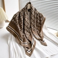 Brown silk scarf with star print and striped border draped over a white shirt - Brown