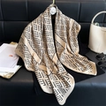 Beige silk scarf with black geometric print draped on sofa with luxury accessories - Khaki / 90x90cm