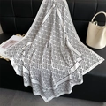 Detail of elegant black and white geometric silk scarf draped on a leather sofa - White / 90x90cm