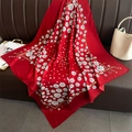 Close-up of red floral silk scarf with polka dots and gold chain pattern on leather - Red (FN233-5)