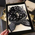 Classic black and white paisley and polka dot silk scarf tied on a display frame - Black and White Patchwork Polka Dot Paisley (LJ21-H170)
