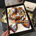 Elegant horse print silk scarf with orange and ivory geometric patterns in luxury setting - Orange Burgundy White Horse Grid (LJ21-H182)