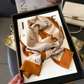 Detailed close-up of a luxury silk scarf featuring horse patterns and orange champagne tones - Classic Orange and Champagne Horse Print (LJ21-H190) / 145x12cm