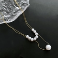 Double-layer gold titanium steel necklace with white natural pearls on black background - 03-K22 Double Layer Shell Pearl Necklace Gold