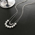 Minimalist double layer necklace with silver metal beads and white pearls on black texture - Titanium Steel Double Layer Bead Necklace