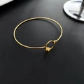 Minimalist golden titanium steel round bead buckle bracelet on a matte black surface - Gold Ball Buckle Style (02-D2)