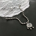 Silver beaded chain bracelet featuring a vintage safety lock pendant with a Fu character - Silver