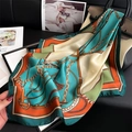 Luxury satin square scarf with chain print in teal blue and orange draped on a handbag - Lake Blue Color Block Equestrian Chain (FJ865-1)