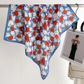 Elegant blue silk square scarf with red tulip prints hanging on a metal rod - 68x68cm / Blue
