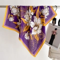 Detail of silk-like square scarf featuring purple lily prints and golden yellow borders - Purple