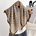 Elegant houndstooth silk scarf with vintage floral patterns hanging on a wooden hanger - Brown