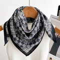 Detail of black and white houndstooth silk scarf hanging on a wooden hanger with tank top - Black