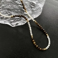 Handmade tiger eye and shell bead necklace with gold spacers on icy texture background - Shell Tiger Eye Mixed Necklace (3)
