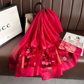 Detail of rose red silk scarf featuring floral embroidery and translucent mesh stitching - Wine Red