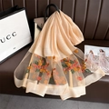 Detail of silk scarf featuring floral embroidery and pearl accents on sheer mesh fabric - Khaki Yellow Floral