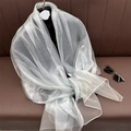 Detail of shimmering silver organza shawl with metallic finish and translucent texture - Light Silver Grey