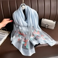 Detail of light blue scarf with 3D floral embroidery and pearls on organza fabric - Blue