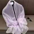 Macro shot of breathable lavender silk blend shawl with subtle pearlescent finish - Light Purple