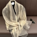 Detail showing the champagne gold silk texture and lightweight shimmer of the long scarf - Apricot Grey