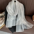 Close-up of lightweight silver silk scarf featuring metallic shimmer and sheer texture - Silver White