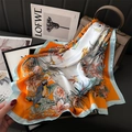 Tropical bird and floral pattern silk square scarf draped on a leather luxury handbag - Blue Border Orange (FJ846-2)