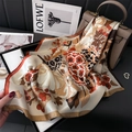 Floral silk square scarf with vintage print and caramel border on a luxury handbag - Coffee
