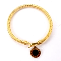 Golden cable cuff bracelet featuring a Roman numeral engraved pendant with a black inlay - Full Gold Color