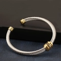 Macro detail of silver cable twist bracelet with golden accents and Greek key pattern - Two-tone Gold (Gold Ends and Center)