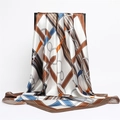 Detail of a large silk square scarf featuring equestrian chain and leather buckle prints - 90x90cm / Brown