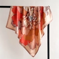 Detailed texture of silk-like satin scarf featuring floral patterns and warm orange tones - 90x90cm / Pink Edge (FT253-1)