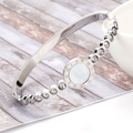 Macro shot of silver steel bangle featuring Roman numerals and sparkling inlaid crystals - Full Steel Color