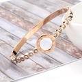 Macro detail of rose gold Roman numeral bangle with zircon rows and mother of pearl inlay - Rose Gold